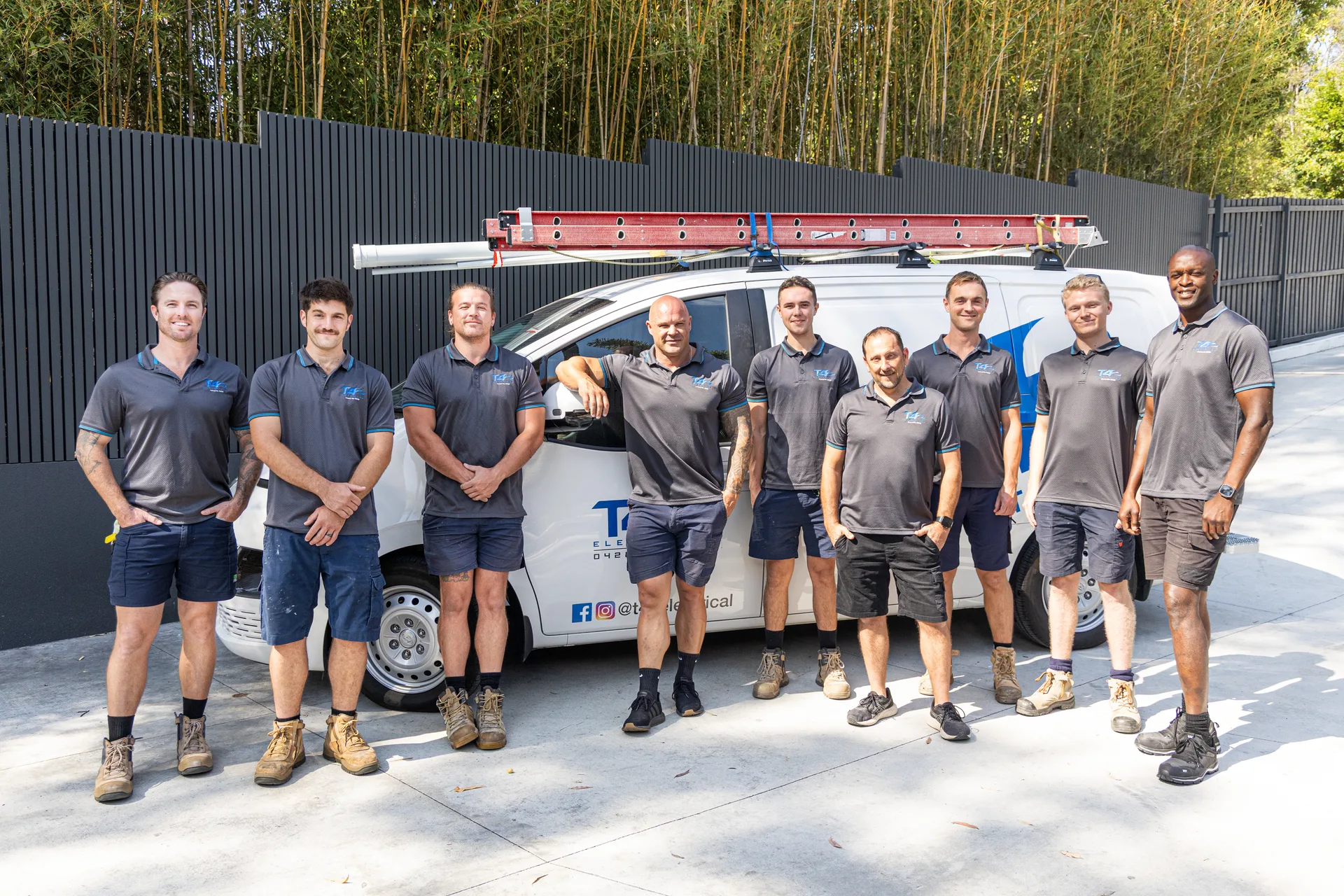 The Family Electrician Coomera team with a service van